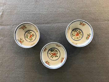Nine Chinese famille verte cups and saucers with birds among blossoms, Kangxi
