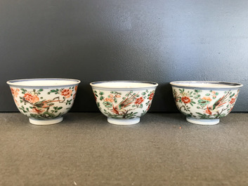 Nine Chinese famille verte cups and saucers with birds among blossoms, Kangxi