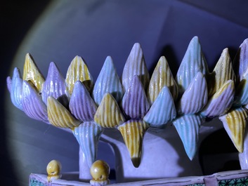 A Chinese verte biscuit group of Guanyin with child on a lotus throne, Kangxi