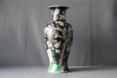 A Chinese famille noire 'magpie and prunus' vase, Kangxi