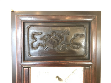 Une armoire en bois sculpt&eacute; orn&eacute;e de 23 plaques en porcelaine de Chine qianjiang cai, 19/20&egrave;me