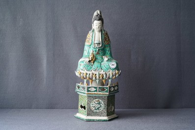 A Chinese verte biscuit group of Guanyin with child on a lotus throne, Kangxi