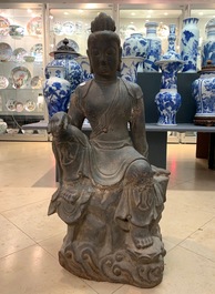 A large Chinese cast iron figure of Guanyin with inscription on the back, Ming/Qing