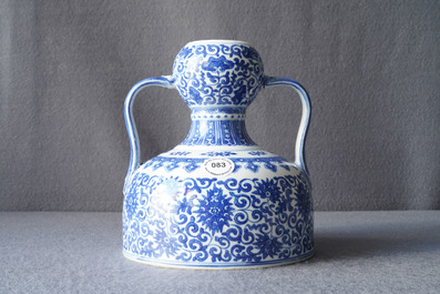 A Chinese blue and white two-handled 'lotus scroll' jug, Qianlong mark, 19/20th C.