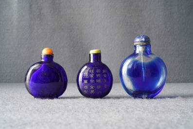 Three Chinese transparent blue glass snuff bottles, one inscribed, 18/19th C.