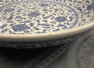 Un plat en porcelaine de Chine bleu et blanc &agrave; d&eacute;cor de rinceaux floraux de style Ming, Qianlong