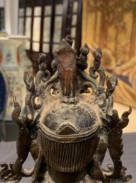 A Chinese bronze figure of Guanyin on a qilin, Ming