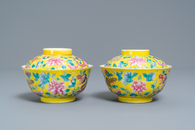 A pair of Chinese yellow-ground famille rose 'dragon and phoenix' bowls and covers, 19th C.