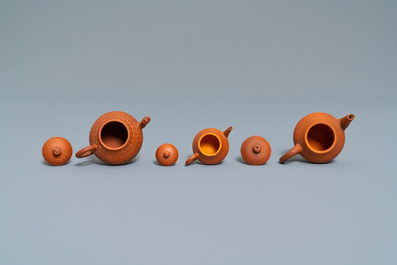 Three Chinese Yixing stoneware teapots and covers, impressed marks, 18/19th C.