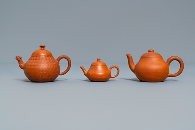 Three Chinese Yixing stoneware teapots and covers, impressed marks, 18/19th C.