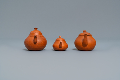 Three Chinese Yixing stoneware teapots and covers, impressed marks, 18/19th C.