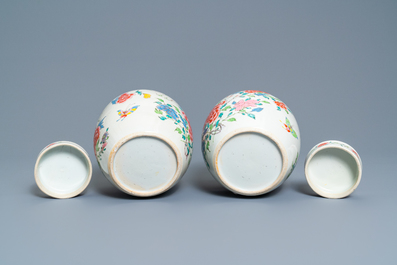 A pair of Chinese famille rose jars and covers with floral design, Yongzheng