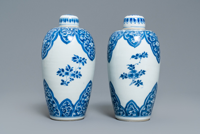 A pair of Chinese blue and white lidded jars with floral design, Kangxi