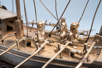 A large Chinese silver model of a junk on carved wooden stand, 19th C.