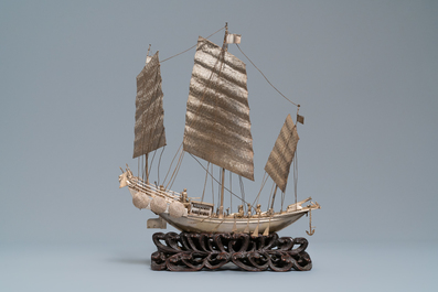 A large Chinese silver model of a junk on carved wooden stand, 19th C.