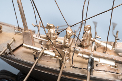 A large Chinese silver model of a junk on carved wooden stand, 19th C.