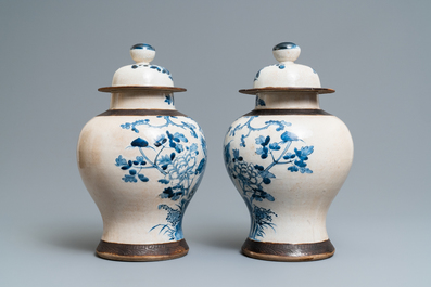 A pair of Chinese blue and white Nanking crackle-glazed vases and covers, 19th C.