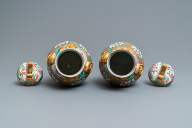 A pair of Chinese Canton famille rose vases and covers, 19th C.