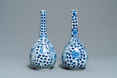 A pair of Chinese blue and white bottle vases with dragons, 19th C.