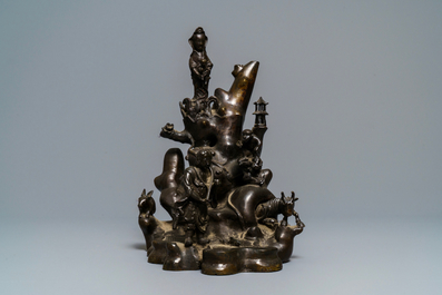 A large Chinese bronze group with Guanyin with child on a rock, Ming