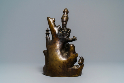 A large Chinese bronze group with Guanyin with child on a rock, Ming