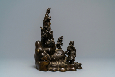 A large Chinese bronze group with Guanyin with child on a rock, Ming