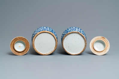 Two pairs of Chinese blue and white vases and covers, 19/20th C.