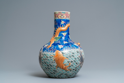 A large Chinese famille rose relief-decorated dragon and carps tianqiu ping vase, Kangxi mark, 19th C.