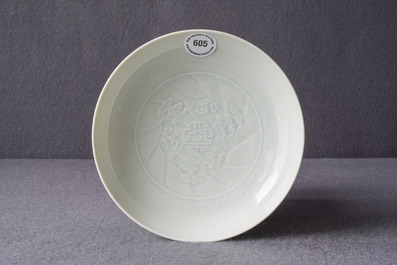 A Chinese celadon saucer dish with underglaze design, Yongzheng mark and poss. of the period