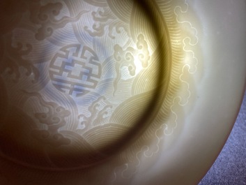 A Chinese celadon saucer dish with underglaze design, Yongzheng mark and poss. of the period