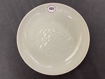 A Chinese celadon saucer dish with underglaze design, Yongzheng mark and poss. of the period