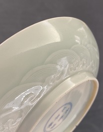 A Chinese celadon saucer dish with underglaze design, Yongzheng mark and poss. of the period