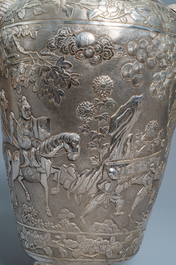 A pair of exceptional large Chinese relief-decorated silver vases, 19th C.