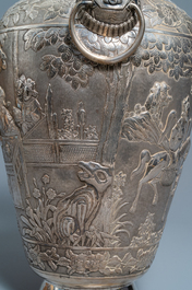 A pair of exceptional large Chinese relief-decorated silver vases, 19th C.