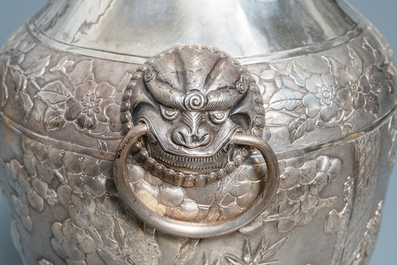 A pair of exceptional large Chinese relief-decorated silver vases, 19th C.