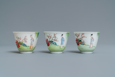 Three Chinese famille rose cups and saucers with figures in a garden, Yongzheng