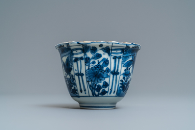 A Chinese blue and white kraak porcelain charger, a vase, a crow cup and a small plate, Wanli