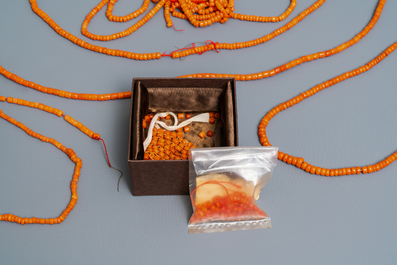 A collection of Chinese necklaces with red coral beads and loose beads, 19/20th C.