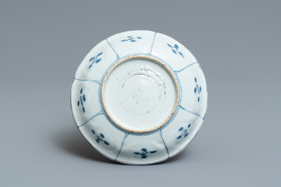 A Chinese blue and white kraak porcelain charger, a vase, a crow cup and a small plate, Wanli