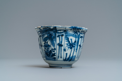 A Chinese blue and white kraak porcelain charger, a vase, a crow cup and a small plate, Wanli