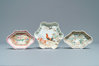 Three Chinese famille rose teapot stands, two spoon trays and a saucer, Yongzheng/Qianlong