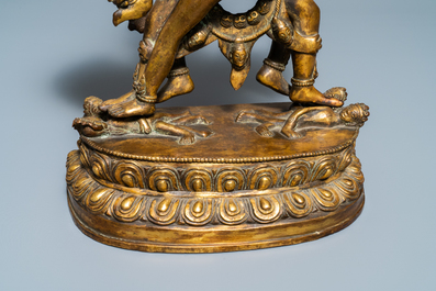 A large Sino-Tibetan coral-inlaid gilt bronze figure of Kapaladhara Hevajra, 18/19th C.