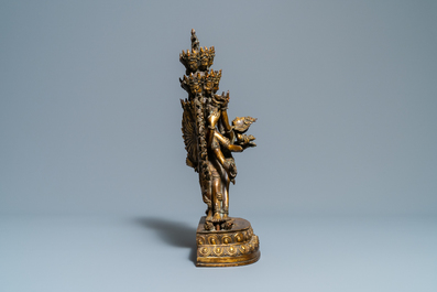 A large Sino-Tibetan coral-inlaid gilt bronze figure of Kapaladhara Hevajra, 18/19th C.