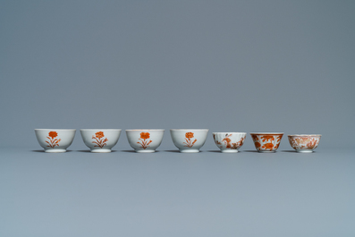 Fourteen Chinese iron-red and gilt cups and nine saucers, Kangxi/Qianlong