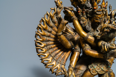 A large Sino-Tibetan coral-inlaid gilt bronze figure of Kapaladhara Hevajra, 18/19th C.