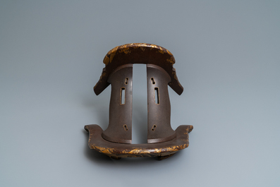 A Japanese gilt-lacquered 'kura' saddle with matching 'abumi' stirrups, Muromachi, 16th C.