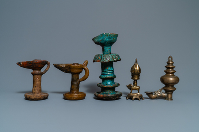 Fifteen islamic bronze and pottery oil lamps, 16th C. and later