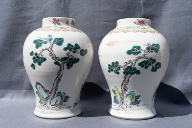 A pair of Chinese famille rose vases with figures in a garden, Yongzheng