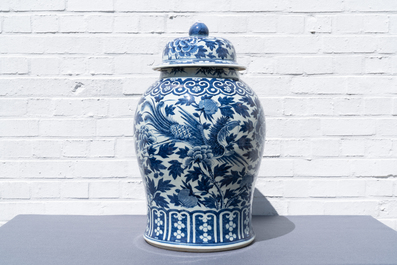 A pair of Chinese blue and white vases and covers with phoenixes, 19th C.