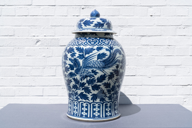 A pair of Chinese blue and white vases and covers with phoenixes, 19th C.